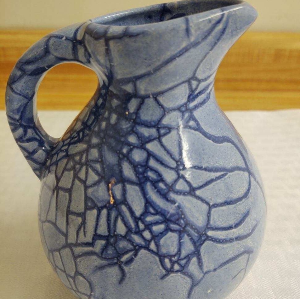 MCM pitcher; ceramic; light blue, dark crackle glaze; bulbous.